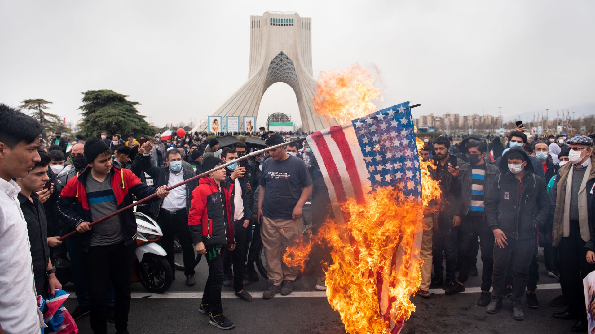 Protestors are seen burning the American flag in Tehran, Iran.