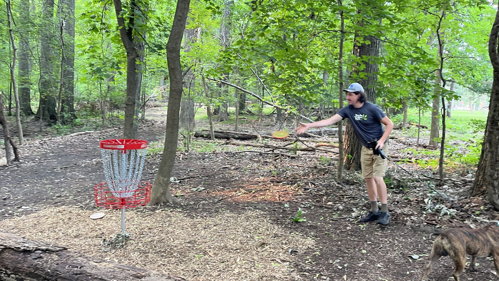 Chris McTaggart finishes a hole at Palmer Park's new beginners disc golf course.