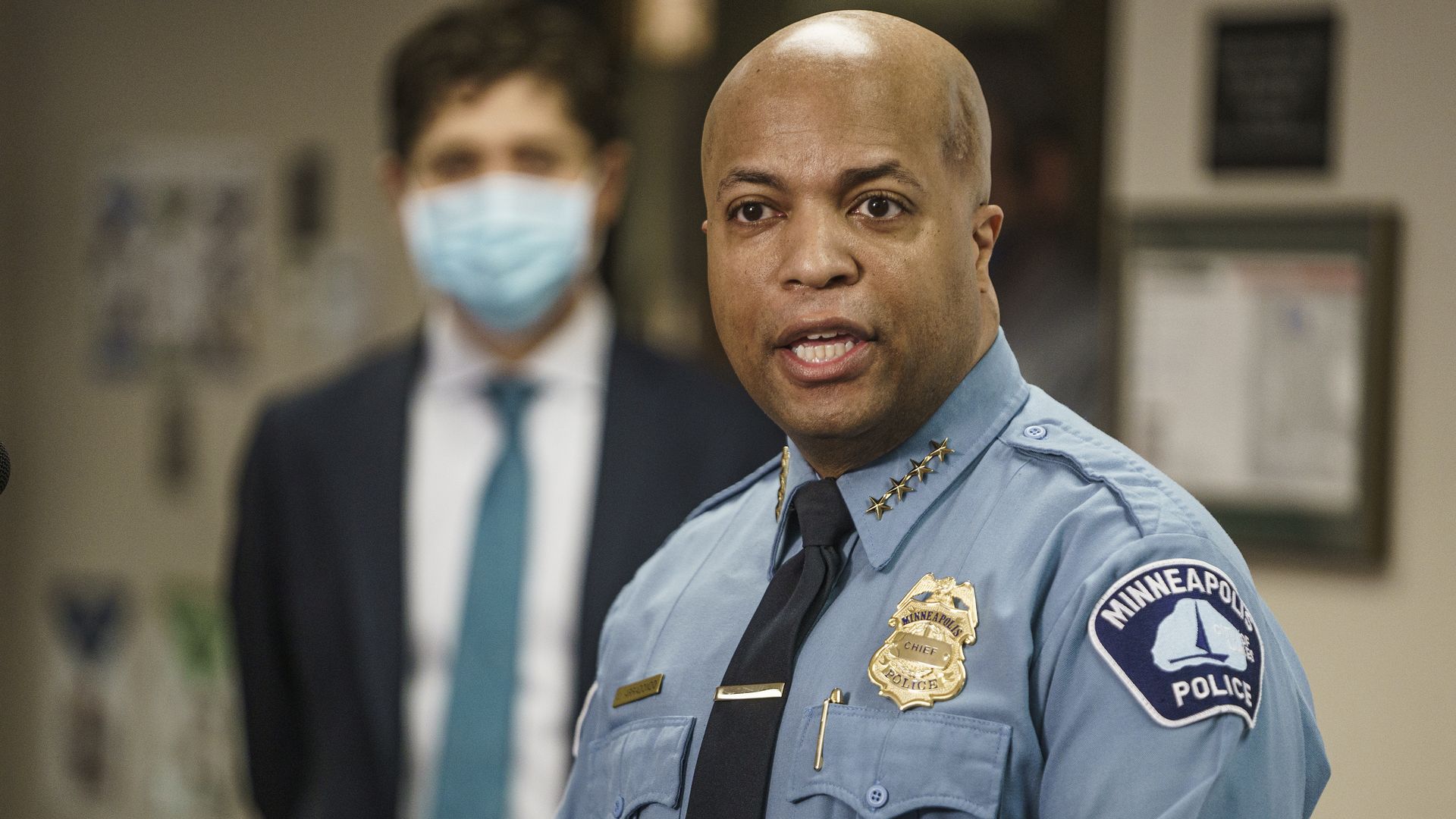 Minneapolis Police Chief Medaria Arradondo stands in front of Jacob Frey