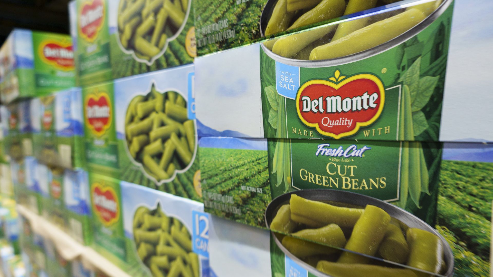 Packages of Del Monte canned green beans are stacked