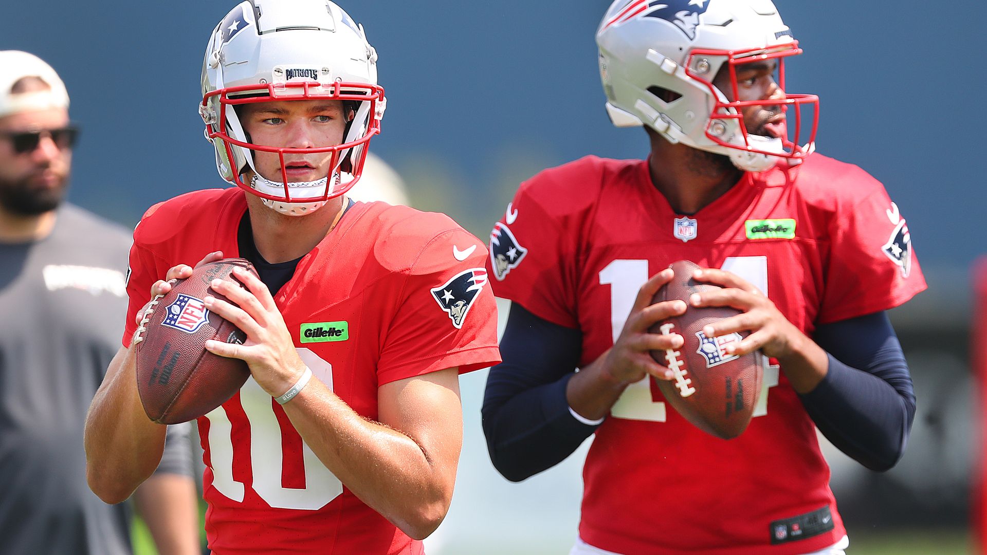 New England Patriots QBs Drake Maye and Jacoby Brissett drop back during a drill. 