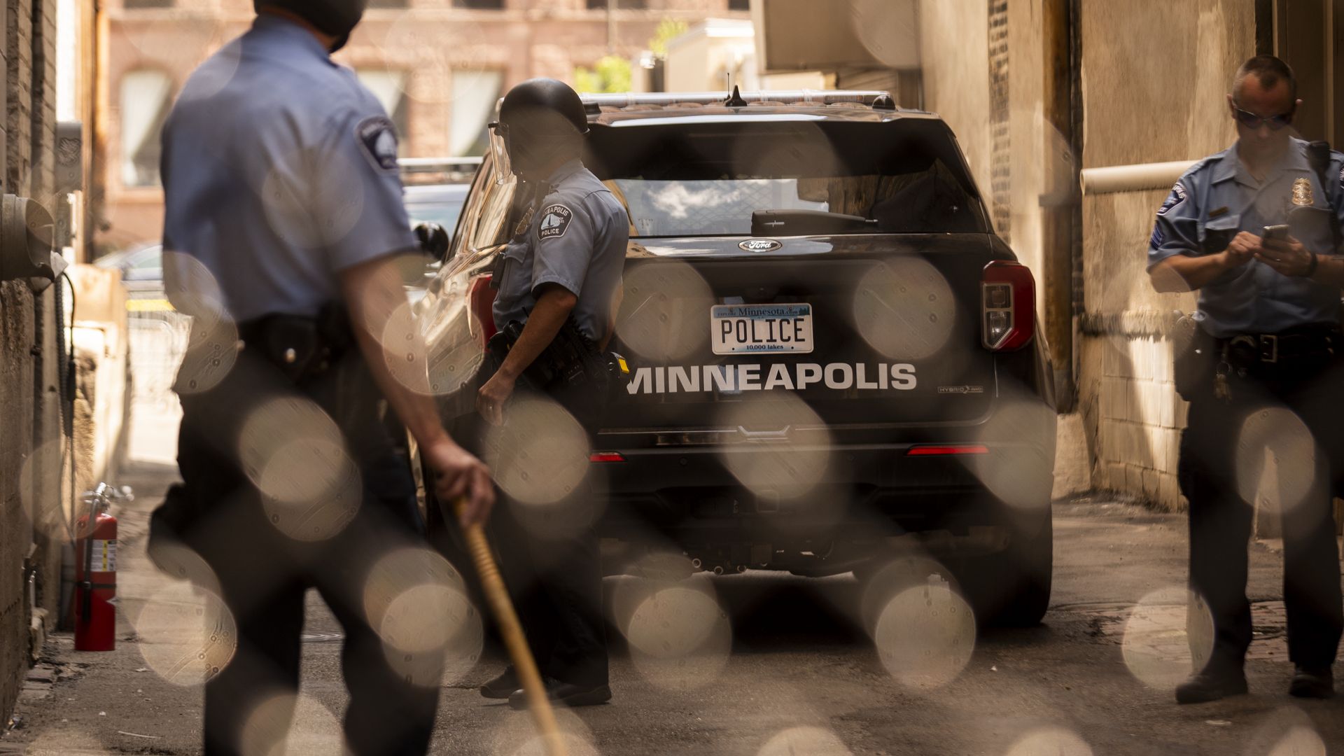 Members of the Minneapolis Police Department seen through a chain link gate on June 13, 2020 in Minneapolis.