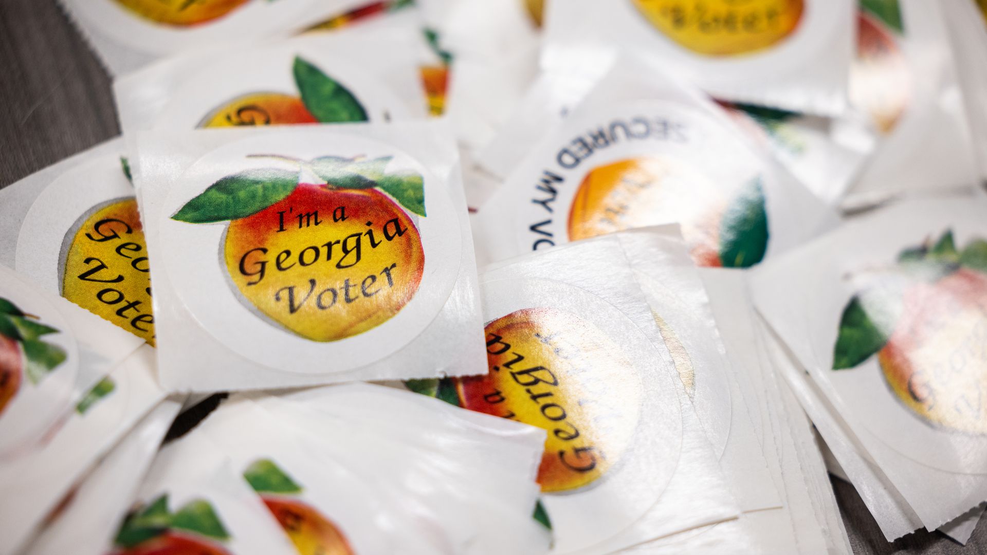 A pile of stickers that read "I'm a Georgia voter" placed on a table. 