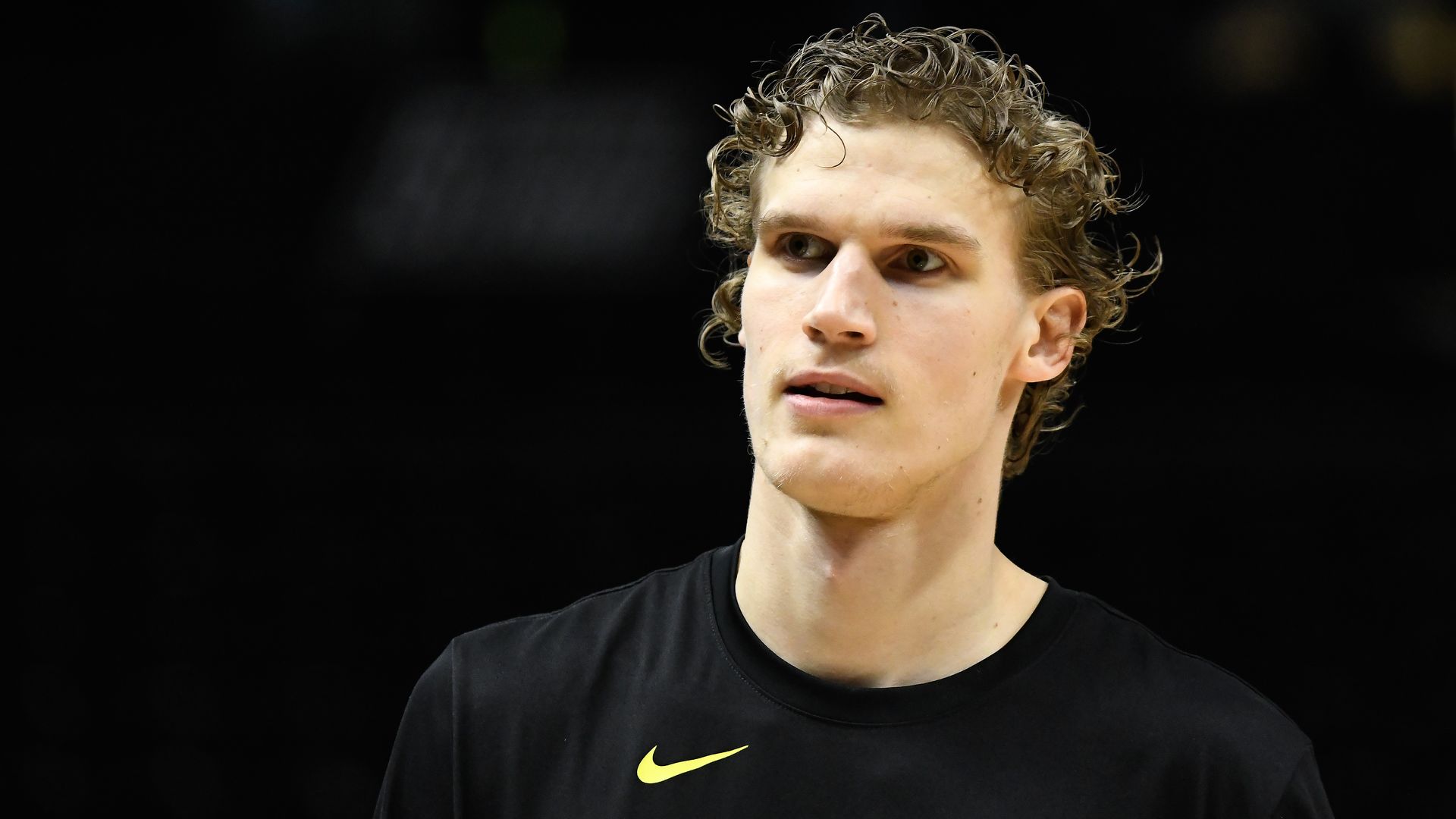 Utah Jazz player Lauri Markkanen wearing a black long sleeve in front of a dark background.