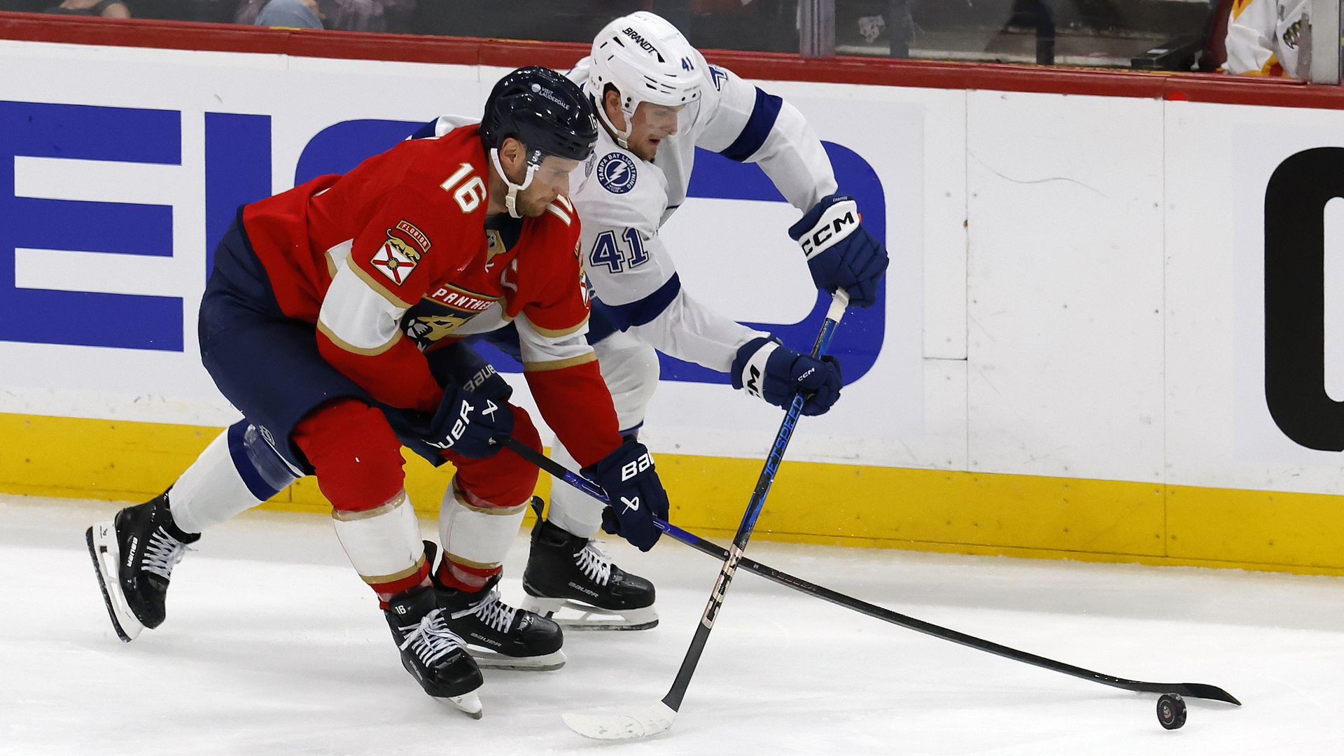 Aleksander Barkov of the Florida Panthers and Mitchell Chaffee  of the Tampa Bay Lightning battle for the puck in the third period of Game Four of the First Round of the 2025 NHL Stanley Cup Playoffs on April 28.