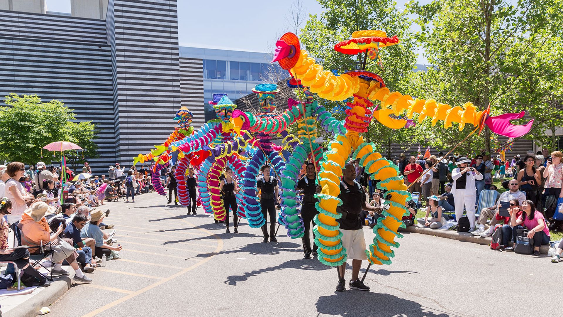A parade featuring colorful, large puppets. 