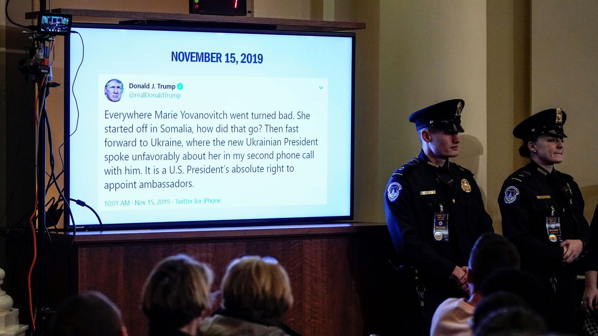 A Trump tweet on a screen in an impeachment hearing room.