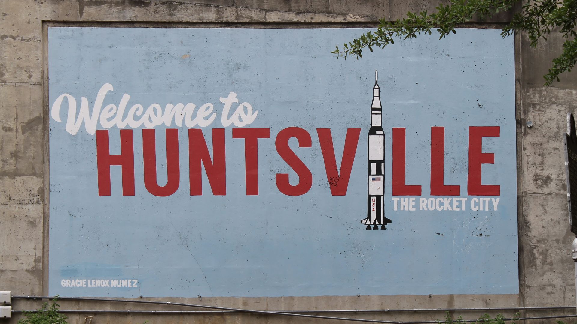 A wall mural reads "Welcome to Huntsville" with a Saturn V rocket instead of an I