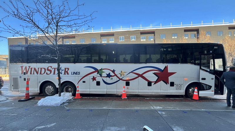 Gif shows an image of a real life coach bus and then another image of a coach bus decked out in World Cup concept art reading "WE ARE KANSAS CITY 26".
