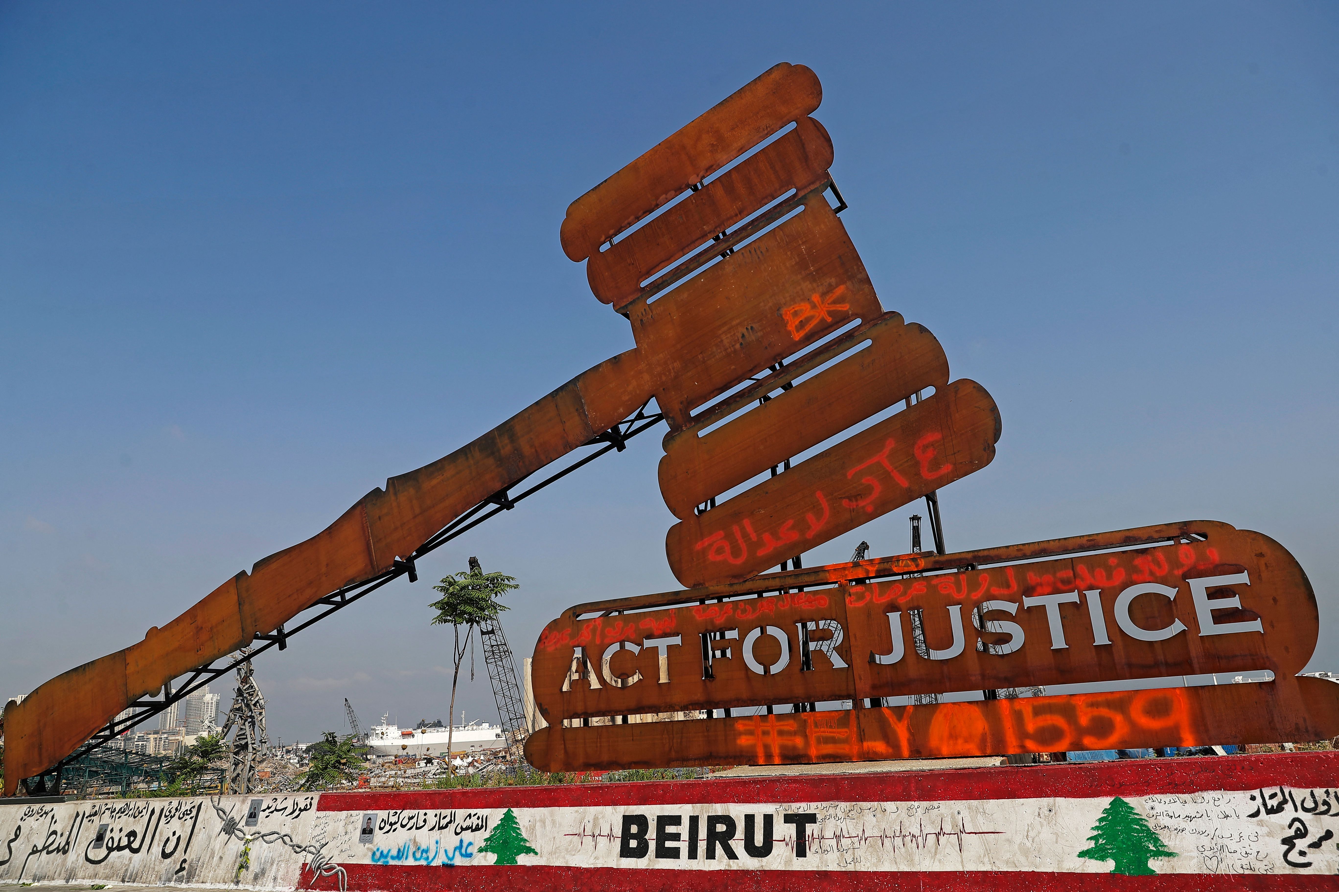 A gavel monument symbolising justice is seen in front of the damaged grain silos at the port on August 4, 2021