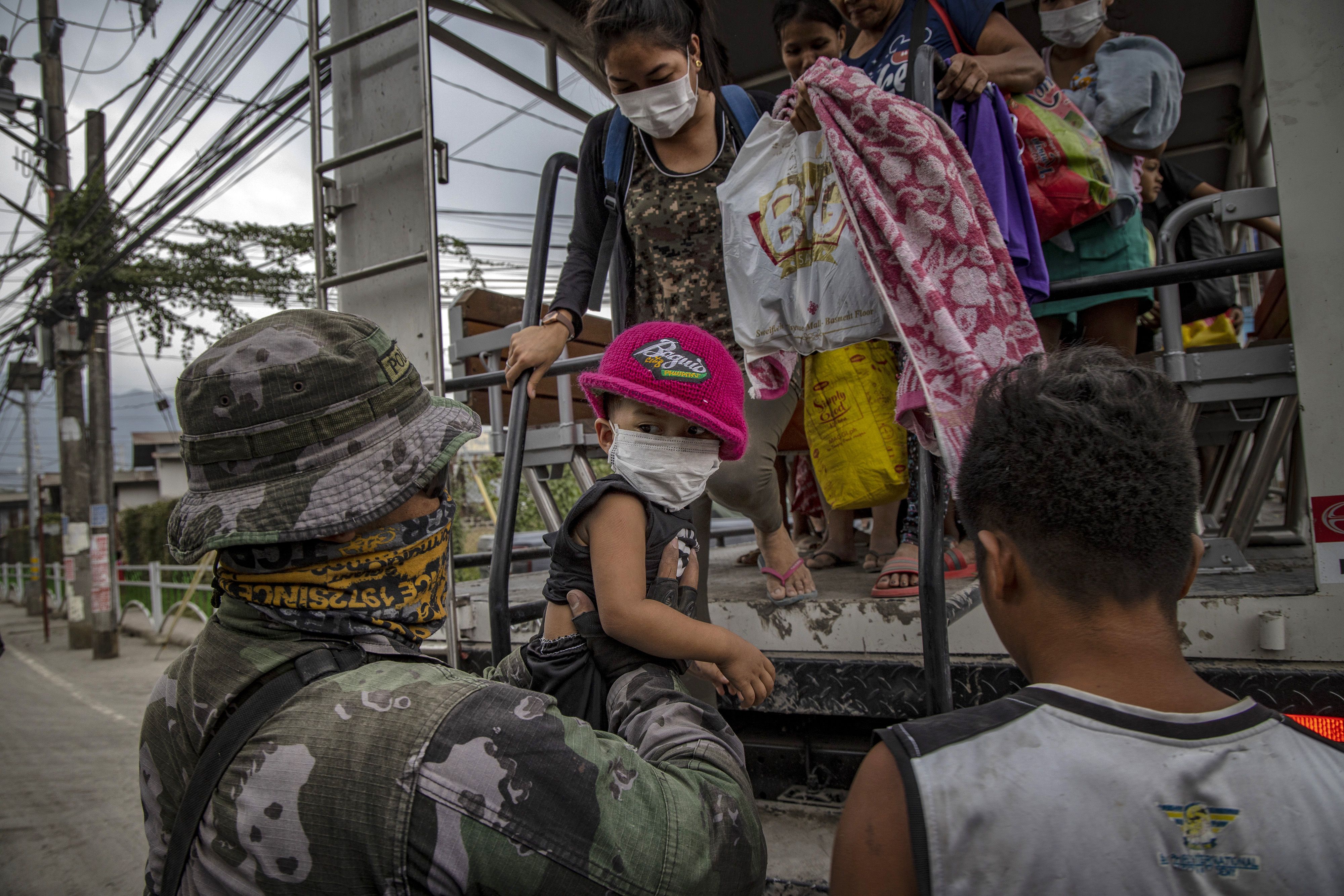Residents fleeing Taal Volcano's eruption arrives at an evacuation center on January 13, 2020 in Santo Tomas, Batangas province, Philippines. 