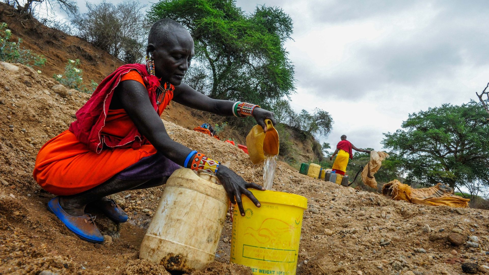 A woman tries to get clean water in Kajiado, Kenya, during a severe drought.