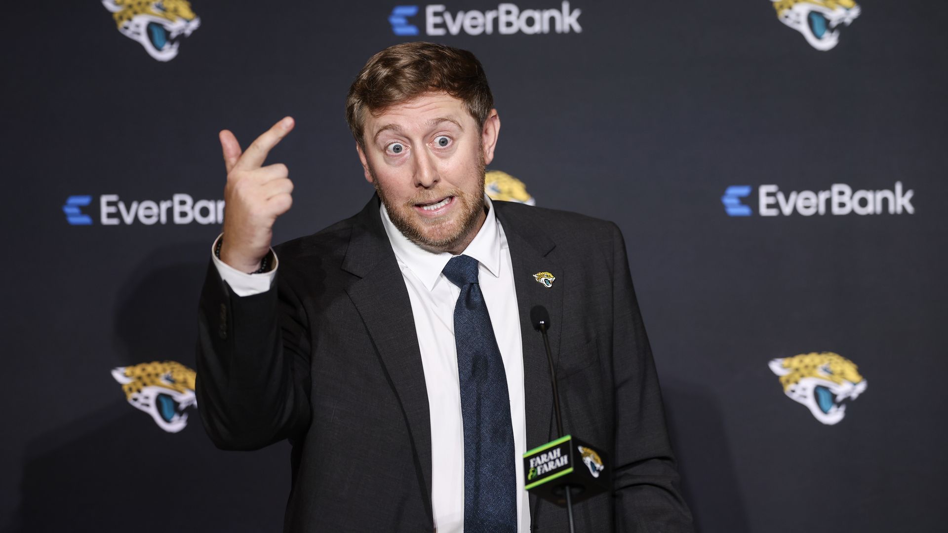 New Jaguars head coach Liam Coen gestures while speaking at a press conference.