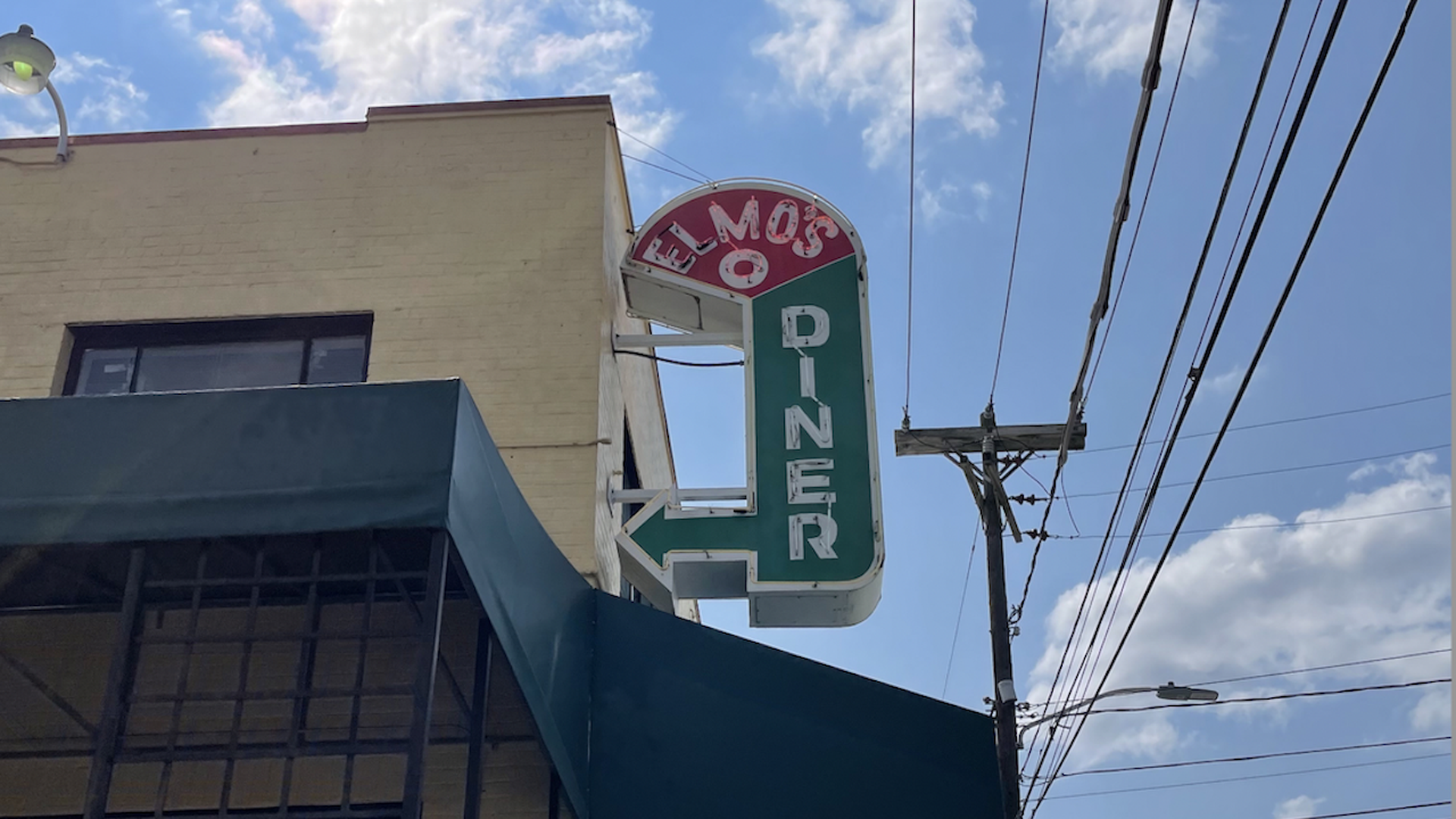 A welcoming neon sign that reads Elmo's Diner. 