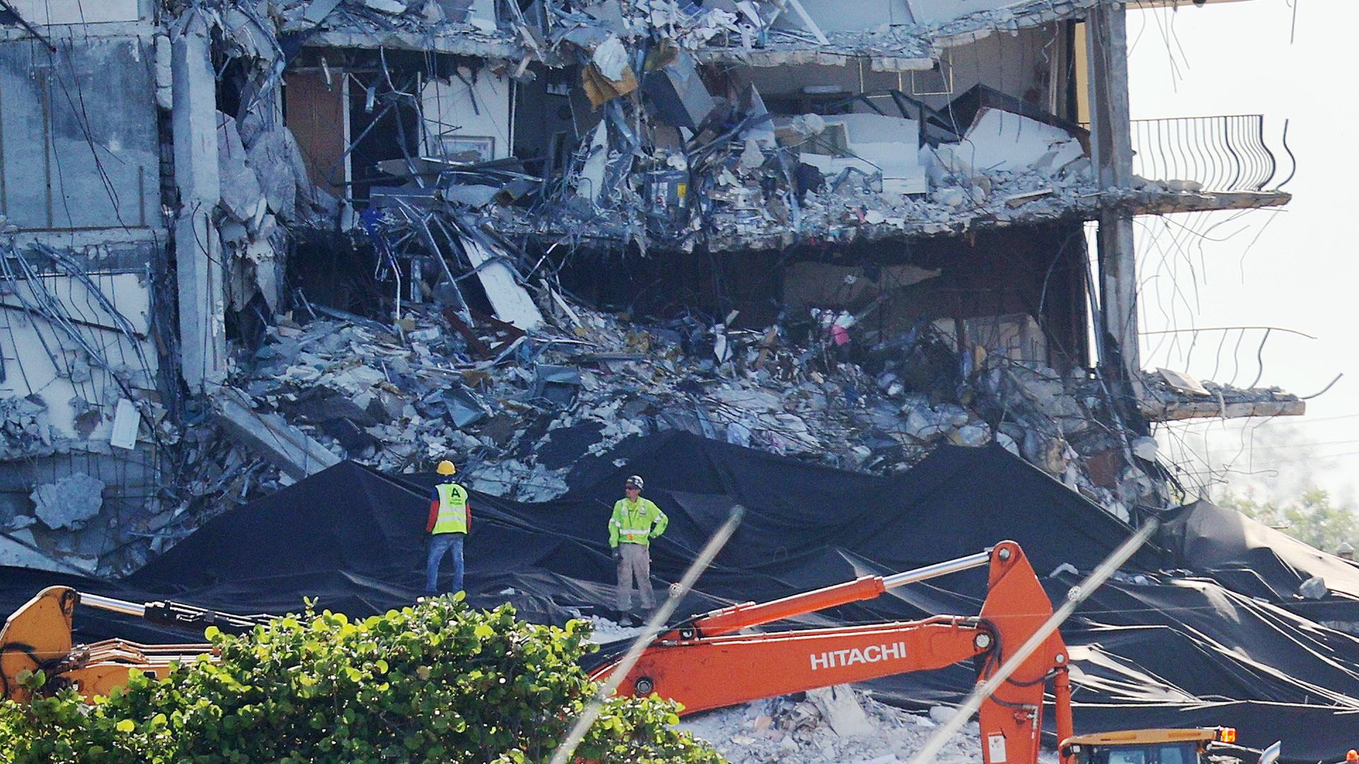 Workers prepare the remaining part of the partially collapsed 12-story Champlain Towers South condo building for a controlled demolition on July 4, 2021 in Surfside, Florida. 
