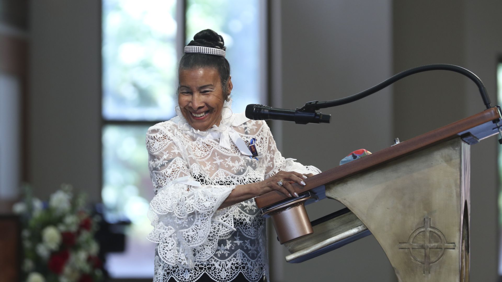 Xernona Clayton smiles at a podium
