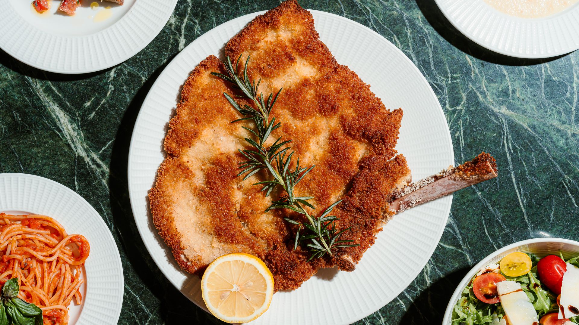 The Milanese with other dishes around it. 