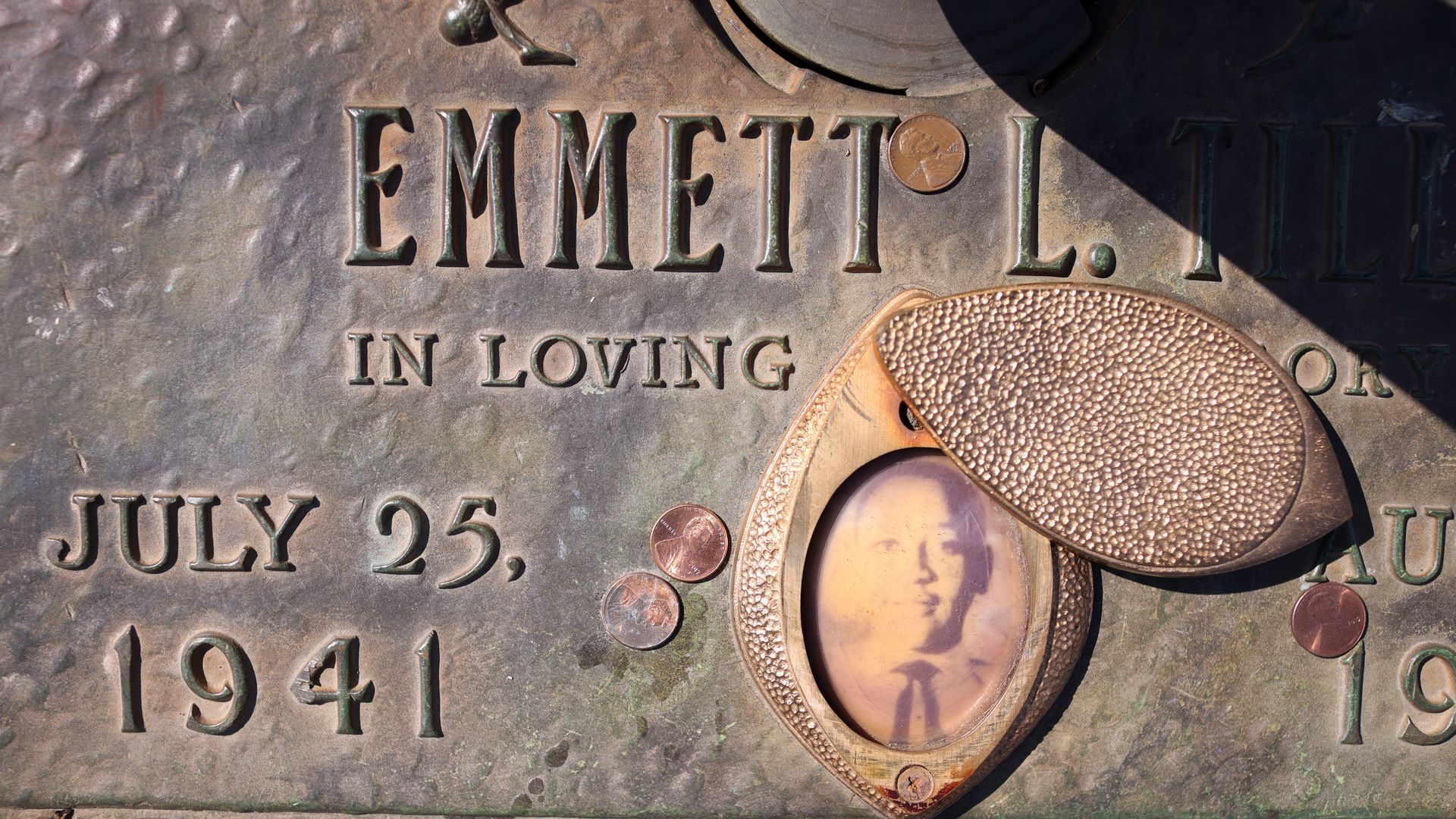 A faded photograph is attached to the headstone that marks the gravesite of Emmett Till in Burr Oak Cemetery in Chicago.