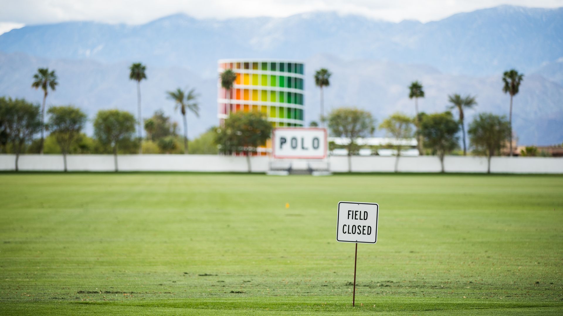 Picture of a field that would normally be used for Coachella with a sign that says "field closed"