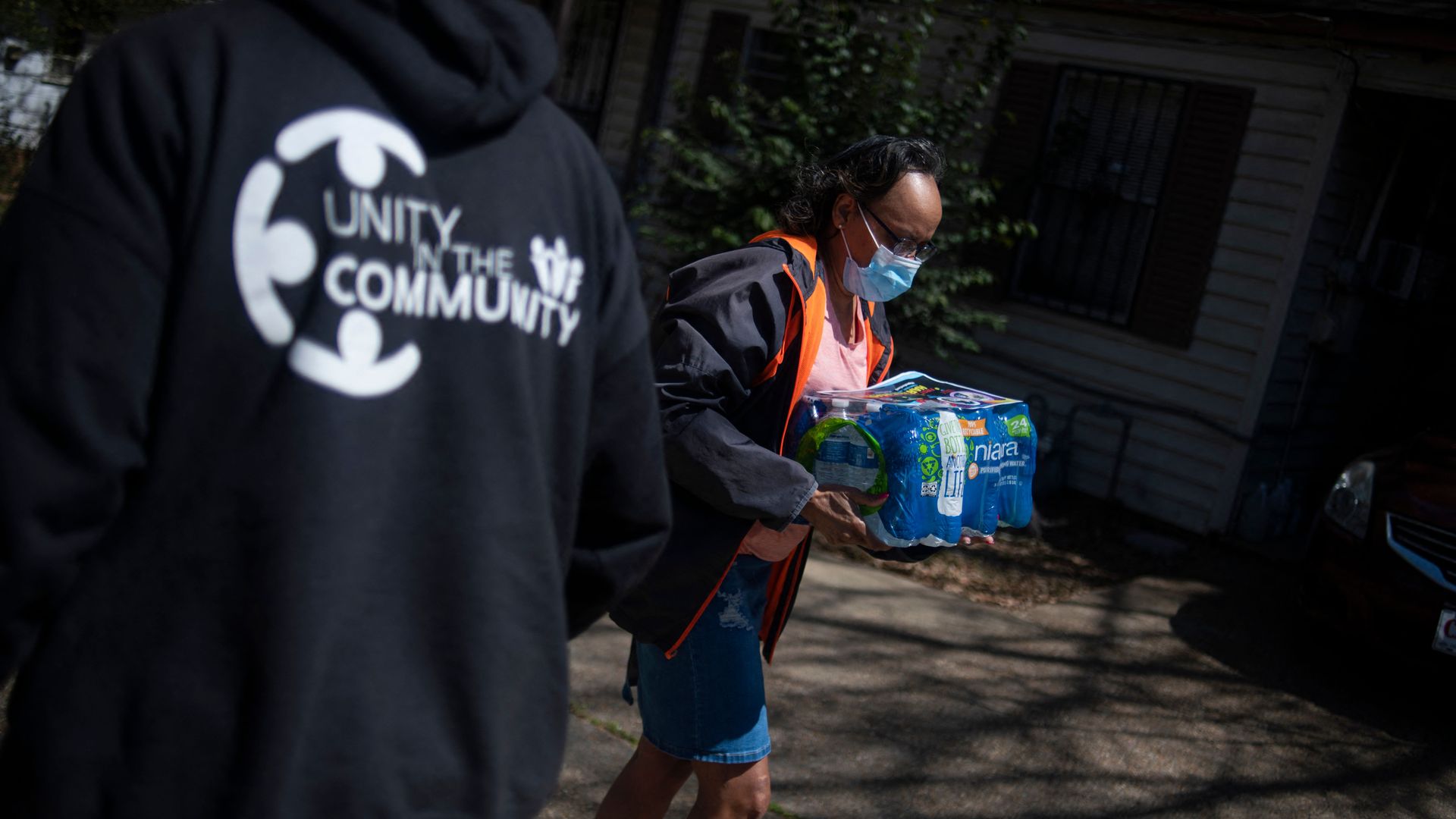 Operation Good hands out a case of water to a resident in Jackson, Mississippi on March 24, 2022.