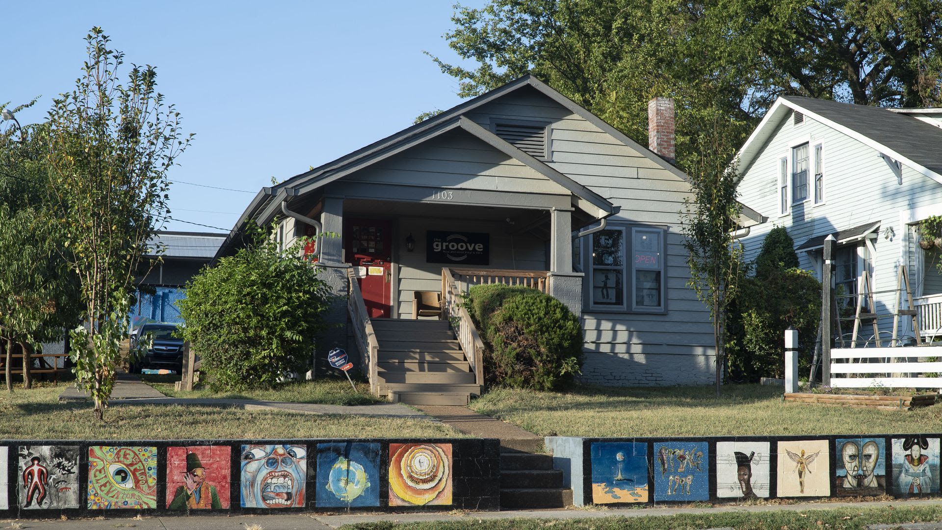 The exterior of the Groove, with murals on the sidewalk out front 