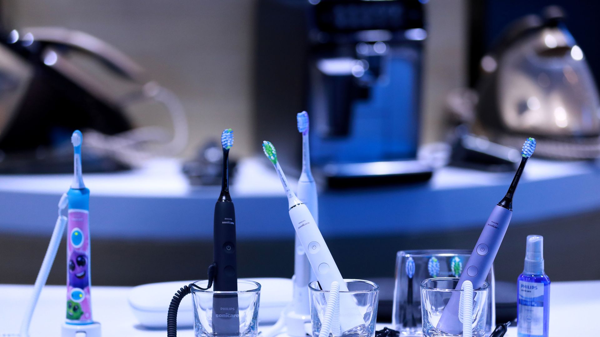 Image of a set of electric toothbrushes in cups on a table