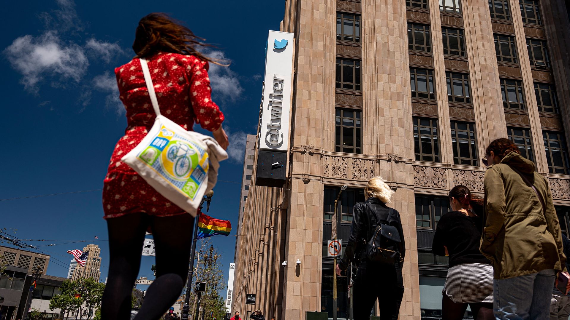 Image of people walking towards the Twitter headquarters in San Francisco, CA.