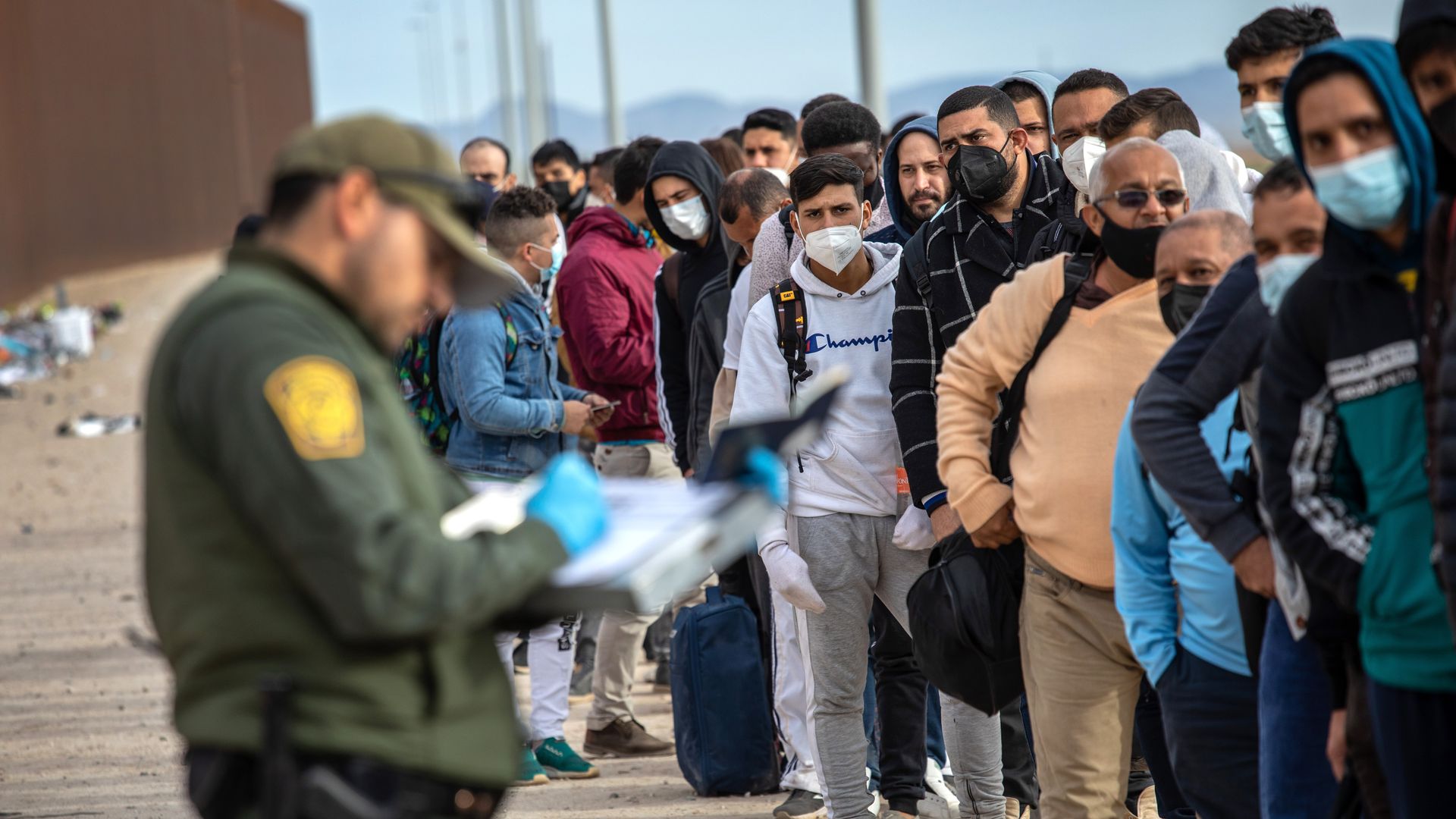 Immigrant men are taken into custody by U.S. Border Patrol agents at the U.S.-Mexico border in Yuma, Arizona. 