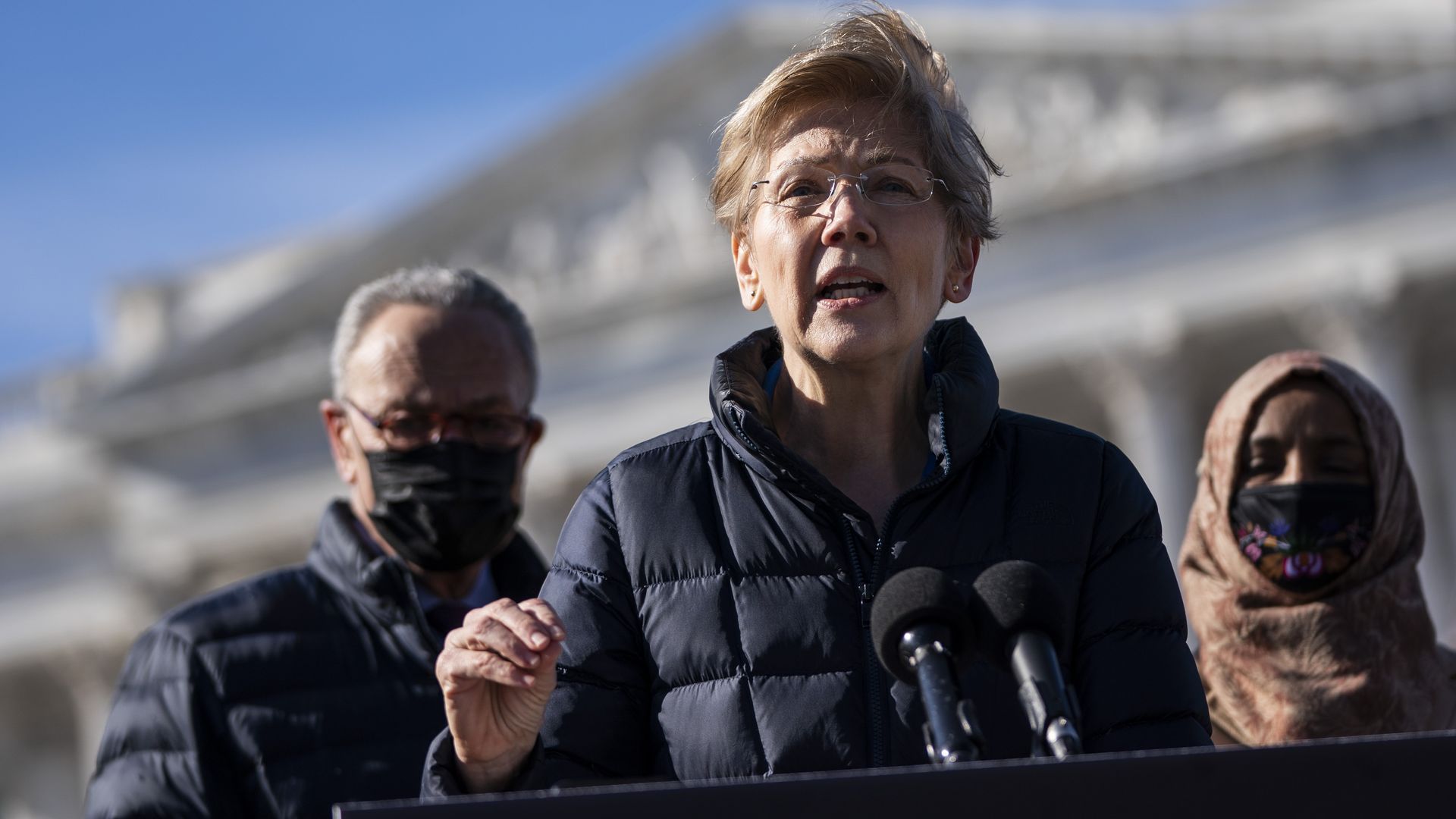 Warren and Schumer stand next to each other.