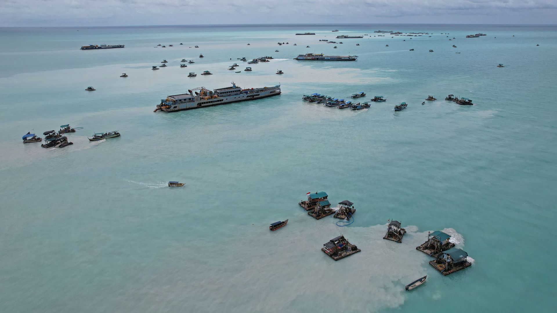 Bamboo rafts and dredging ship used to dredge for tin ore in the Matras Beach area in Sungai Liat, Bangka Island, Indonesia, on Monday, Sept. 5, 2022.