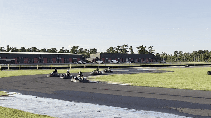 image shows people driving go-karts