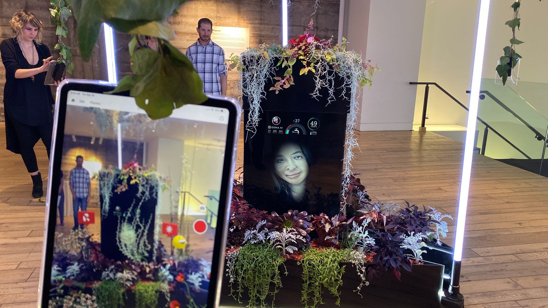 An image of Osma.ai, an augmented reality art project in which a terrarium is watered based on how many likes its AI-generated selfies get on Instagram