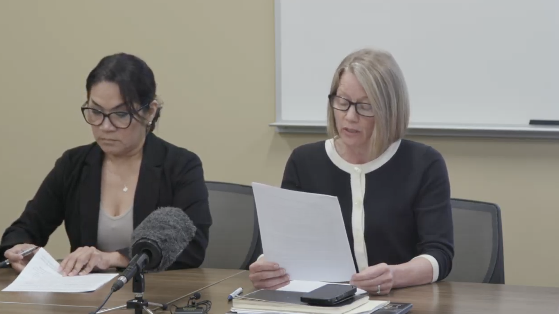 Des Moines school board president Jackie Norris reads from a statement.