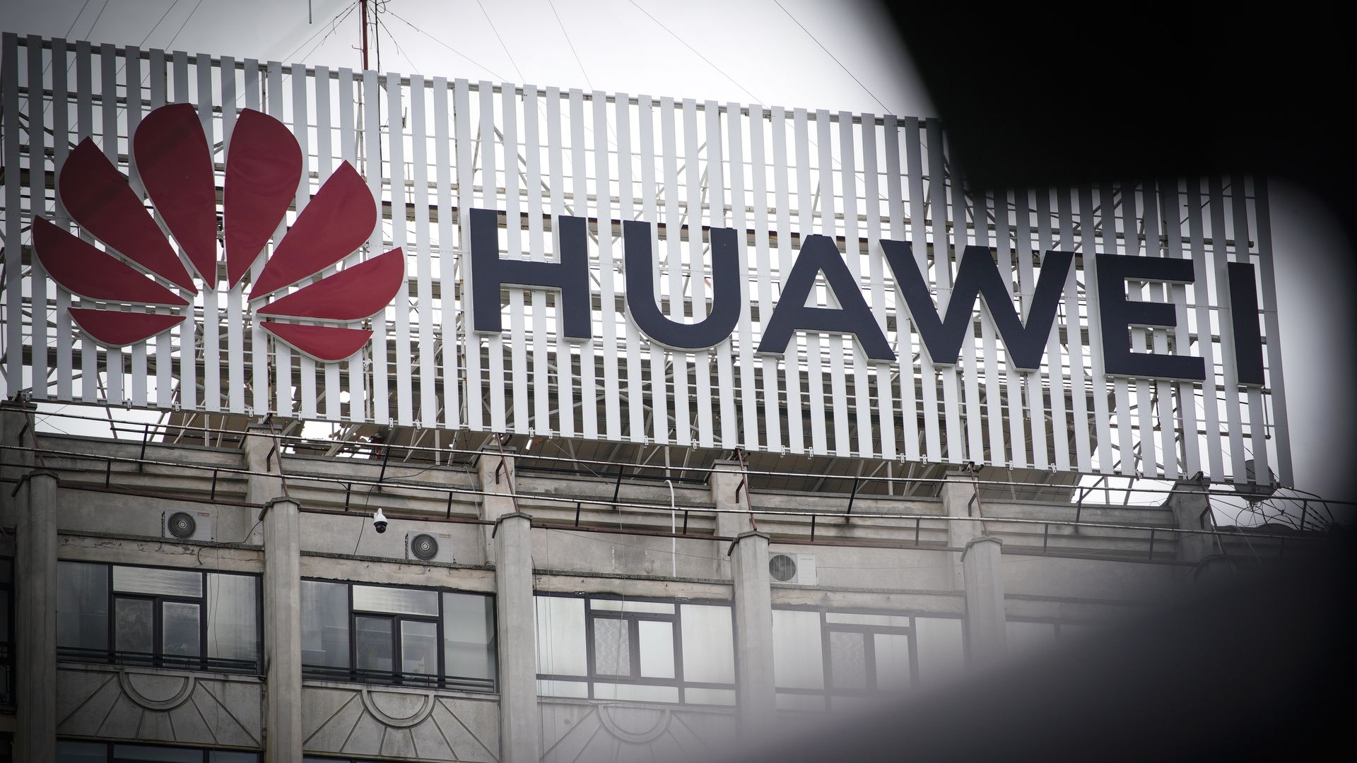 In this image, the Huawei sign and logo is displayed prominently on a building.