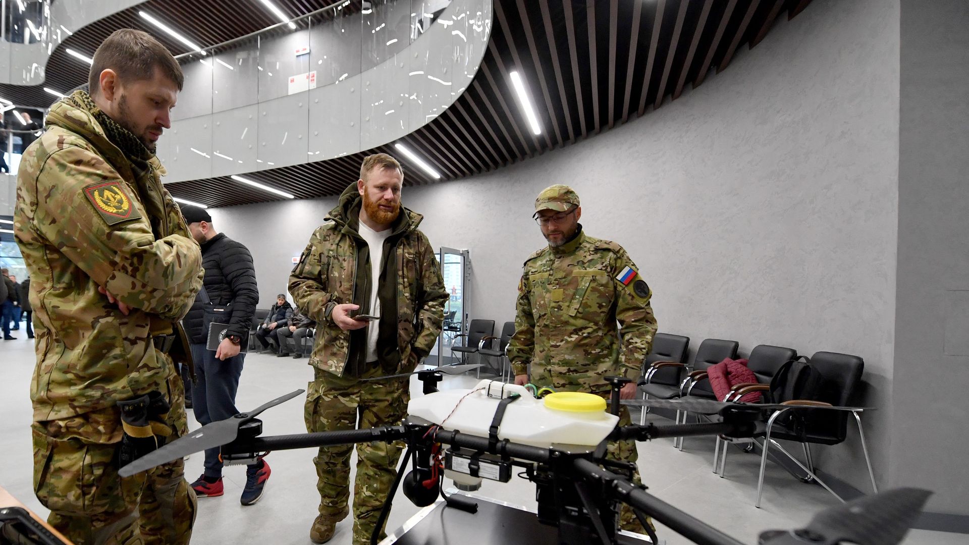 People looking at a drones on display inside the Wagner Group's headquarters in St. Petersburg, Russia, in November 2022.