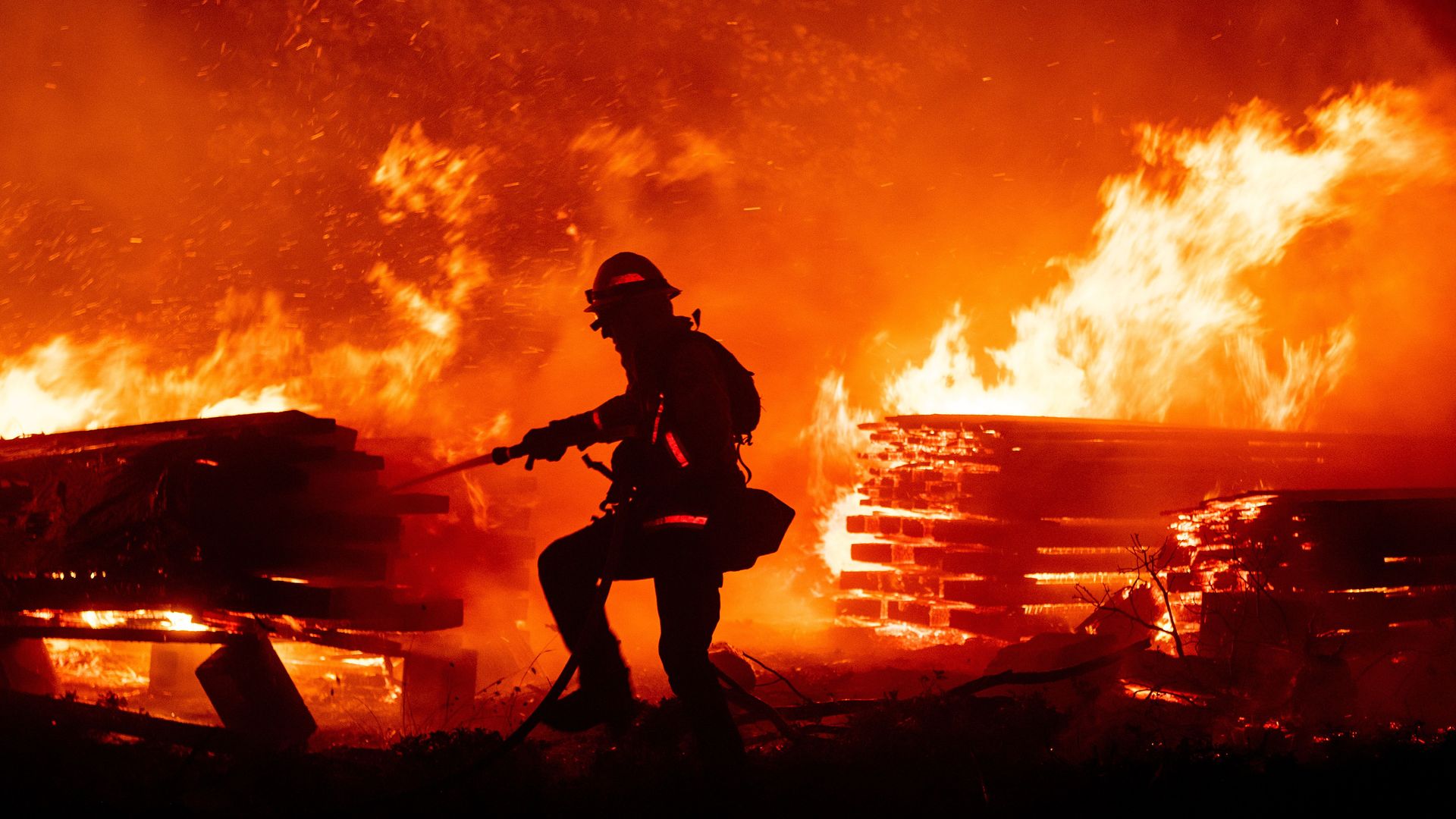 A firefighter hosing flames during the Creek fire in Madera County, California, in September 2020.