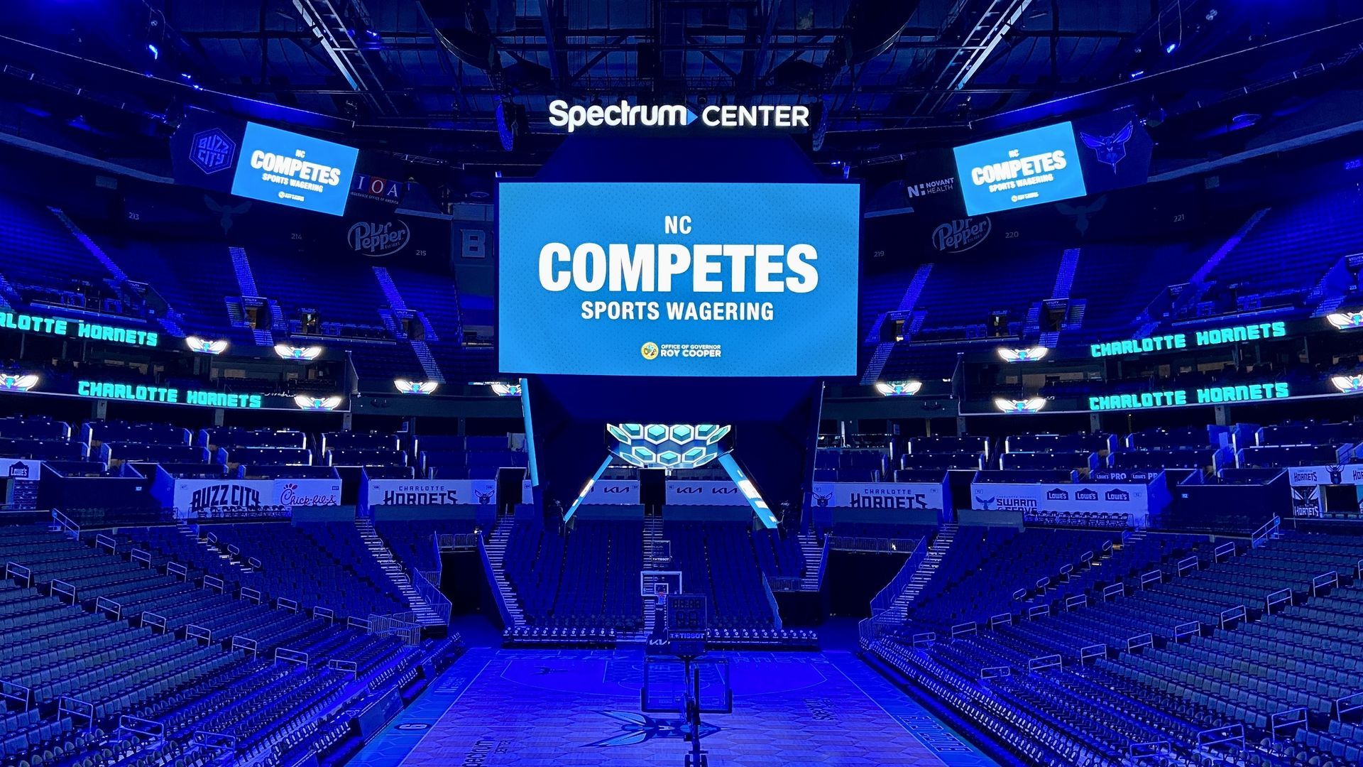 Spectrum Center jumbotron lit up with "NC Competes Sports Wagering." 
