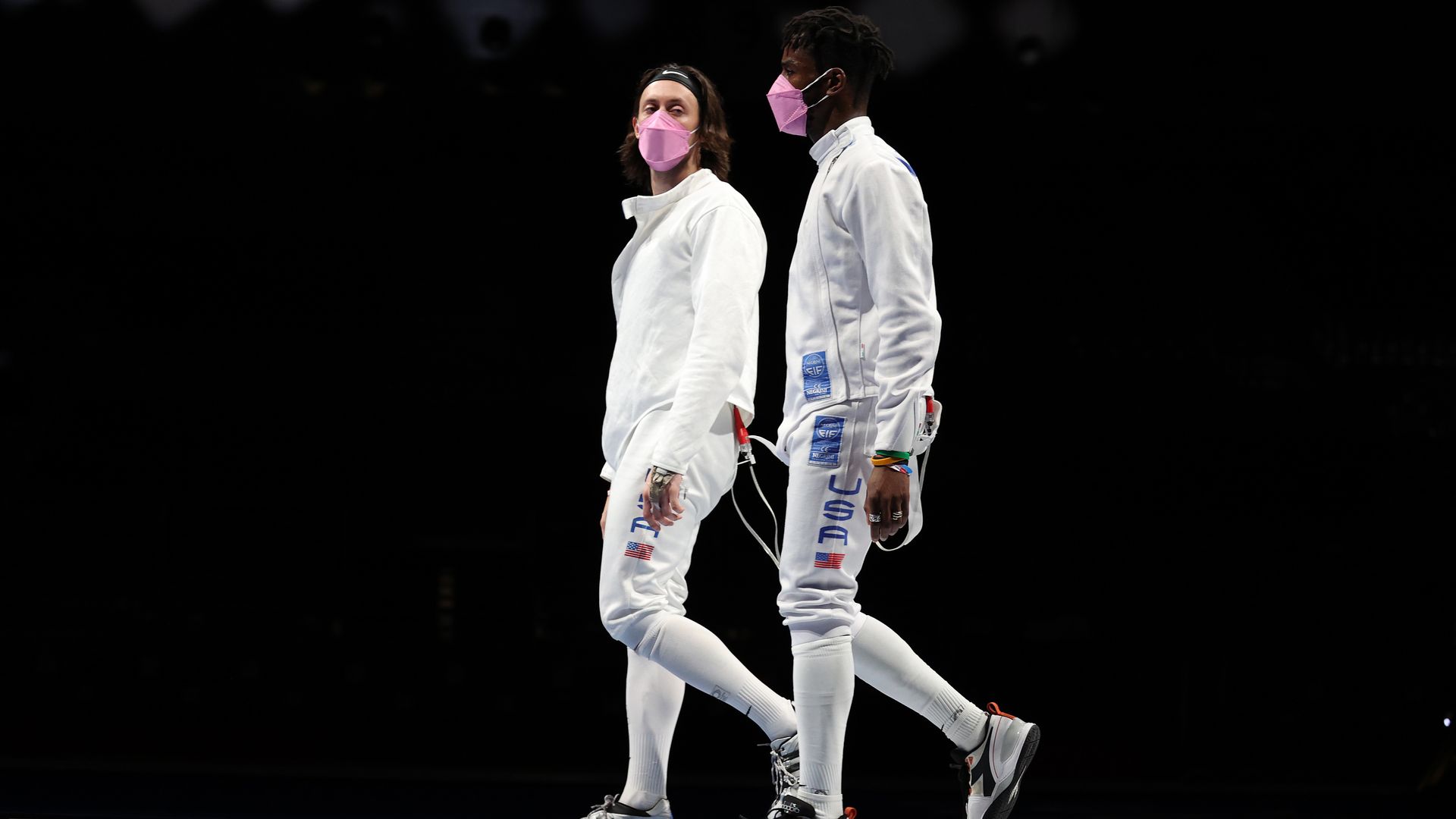Jacob Hoyle of Team United States, left, and Curtis McDowald of Team United States react to their loss to Team Japan in Men's Épée Team