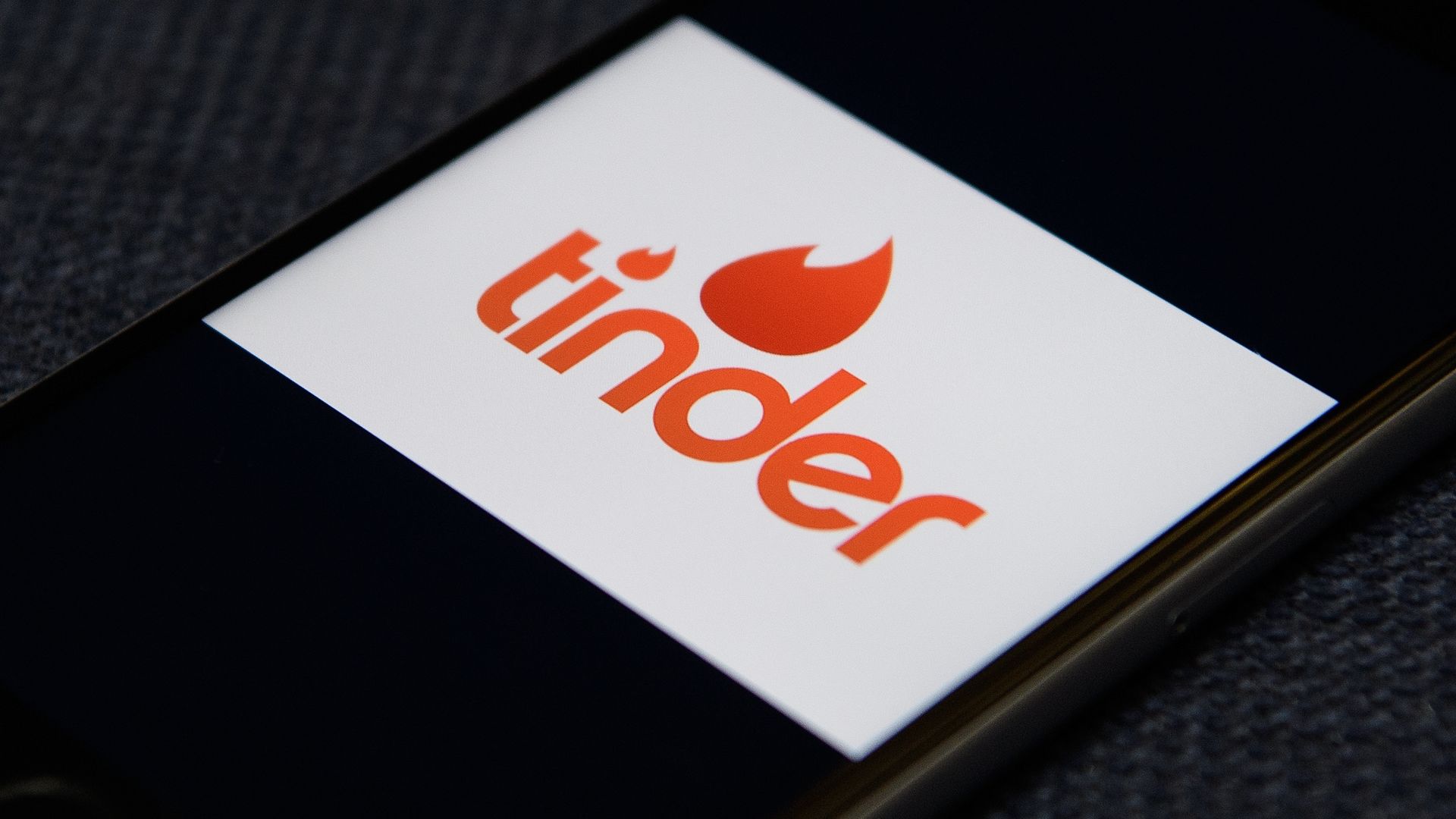The "Tinder" app logo is seen on a mobile phone screen on November 24, 2016 in London, England.