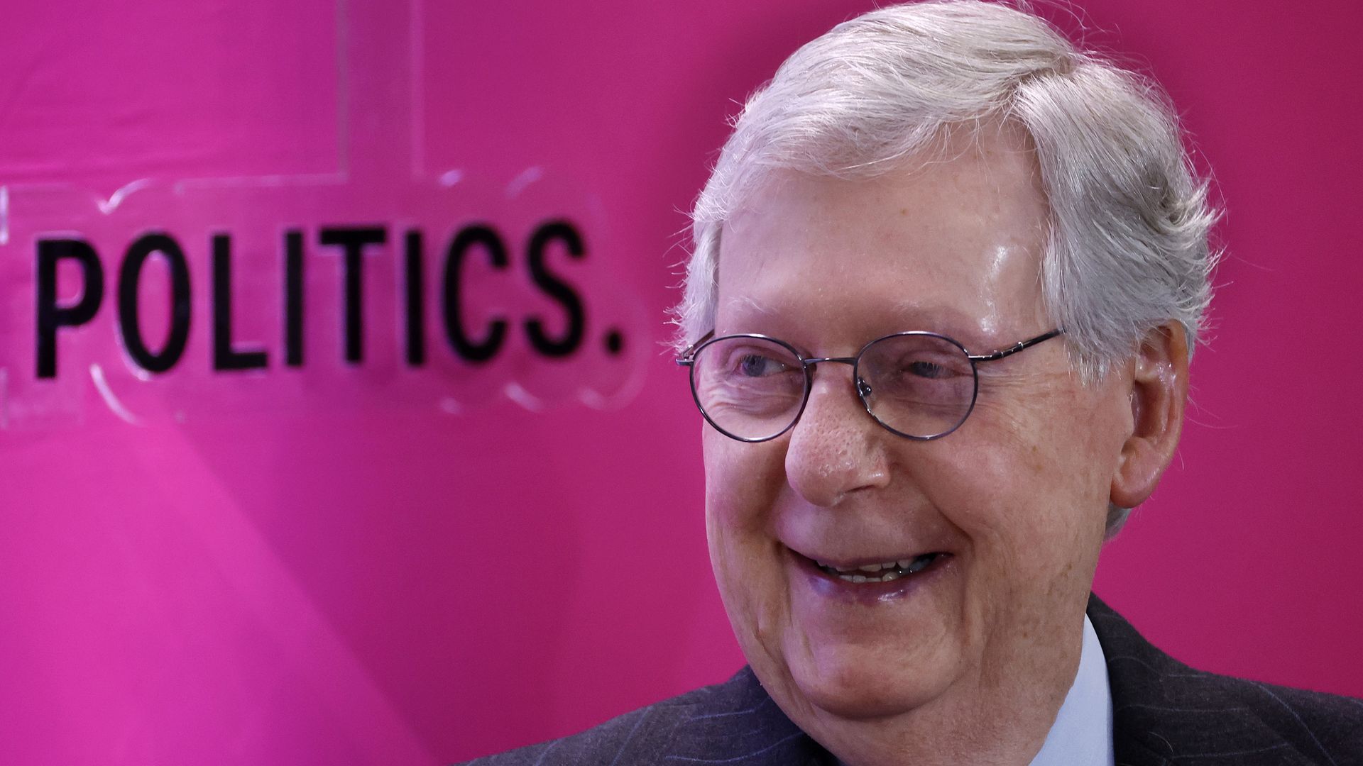 Mitch McConnell smiles during an onstage interview