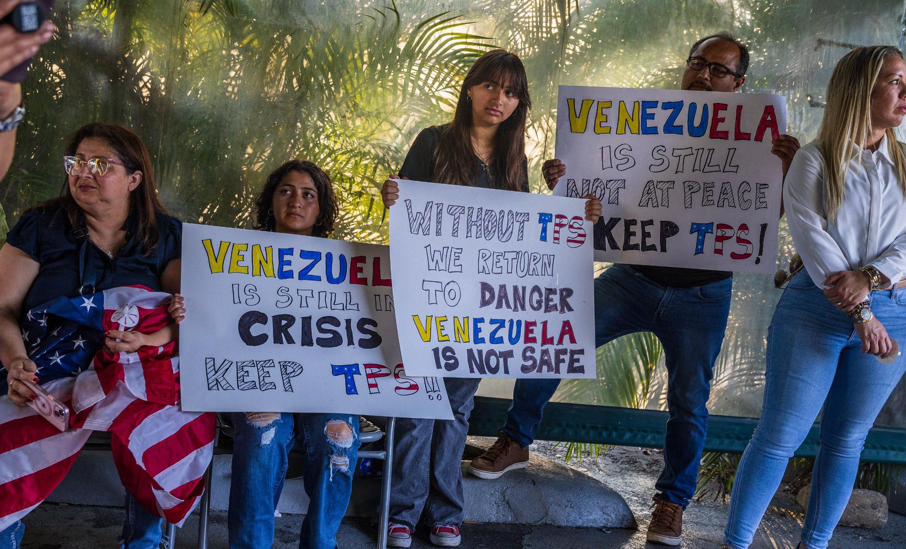 Venezuelans held posters describing the actual situation in the country during a vigil held in Doral, Florida, by the Venezuelan American Caucus in support of the extension of the TPS for Venezuelans that were forced to leave their country due to the dictatorship lead by Nicolas Maduro, on Thursday,
