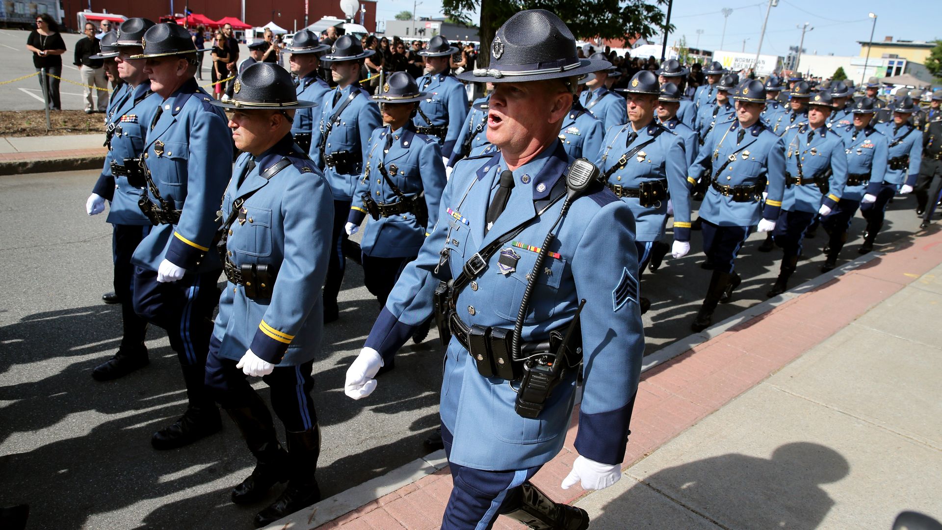 State Police troopers walk down sidewalk