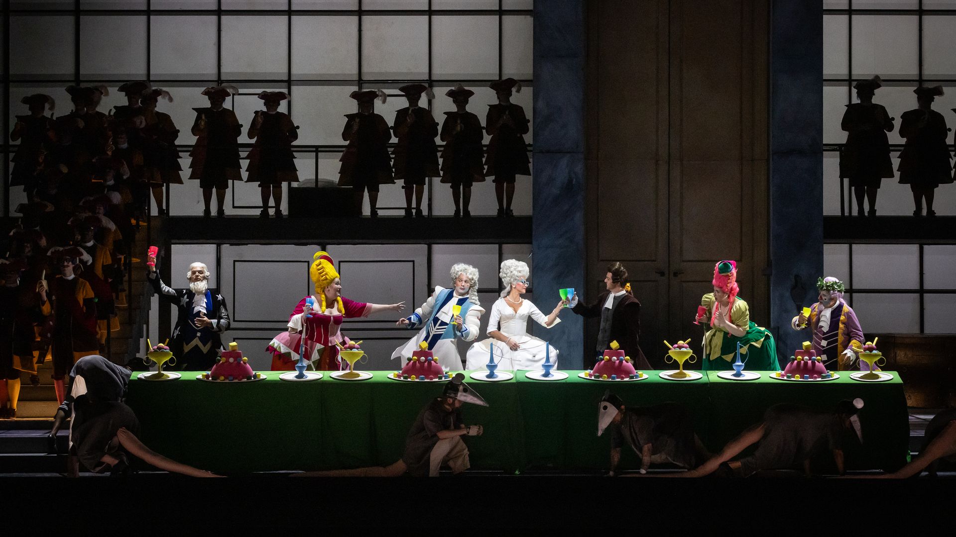 Cinderella opera on stage with over a dozen people in costumes. 