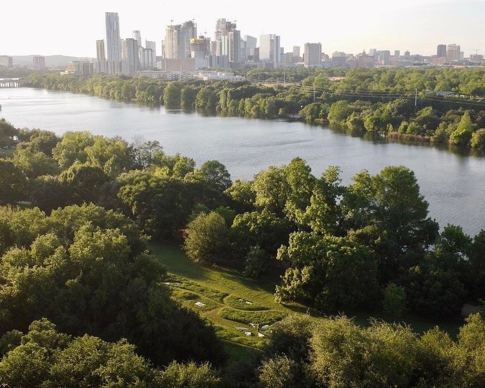 A photo of art installation with the skyline in the background.