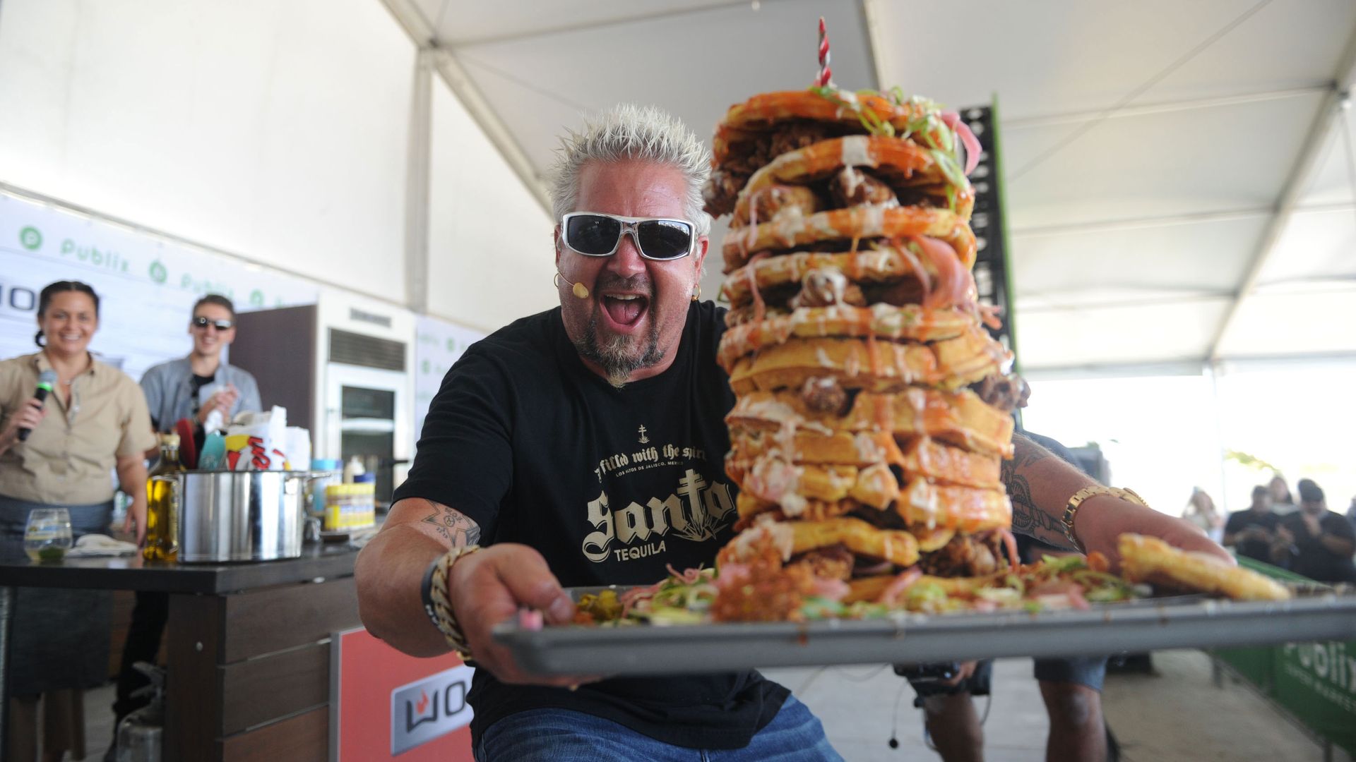 Guy Fieri holds a tray with a stack of waffles