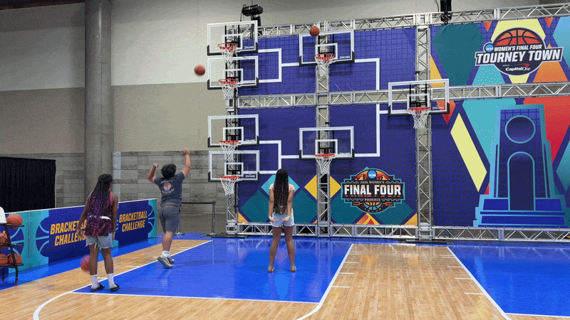 A gif of kids shooting baskets with "Fina Four" branding.