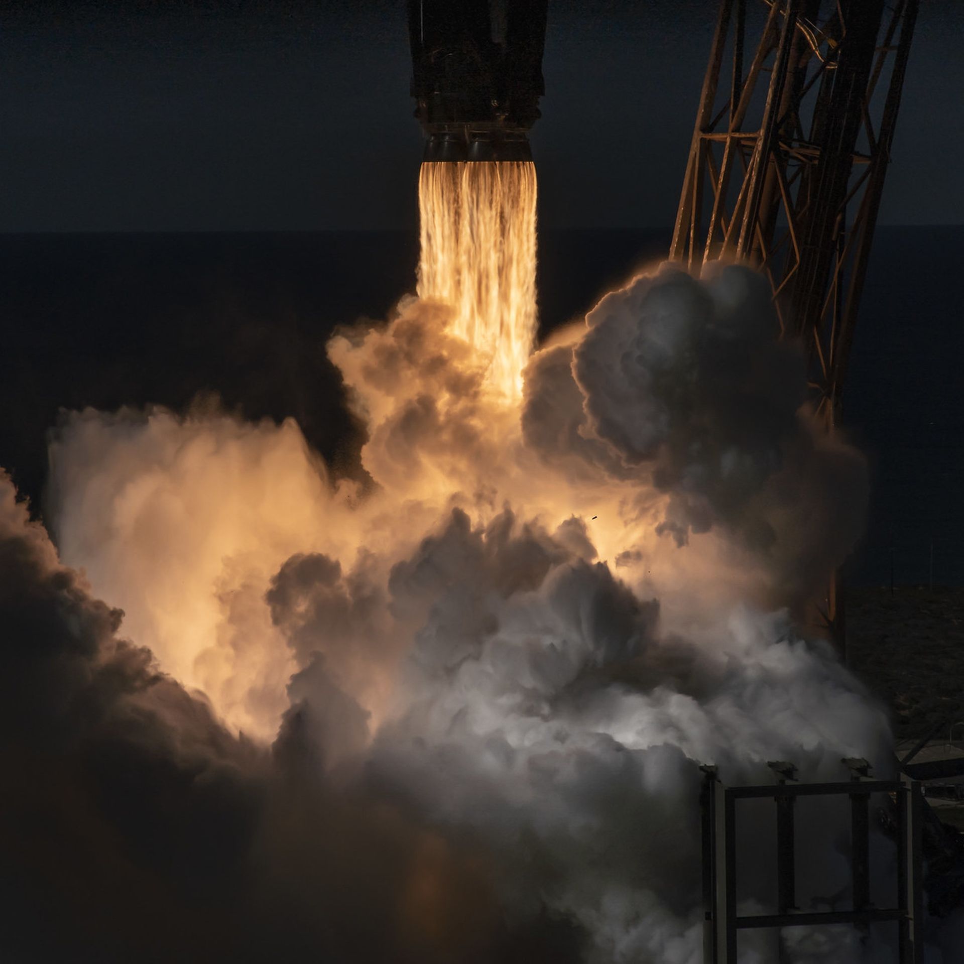 A close-up of a rocket launching to space