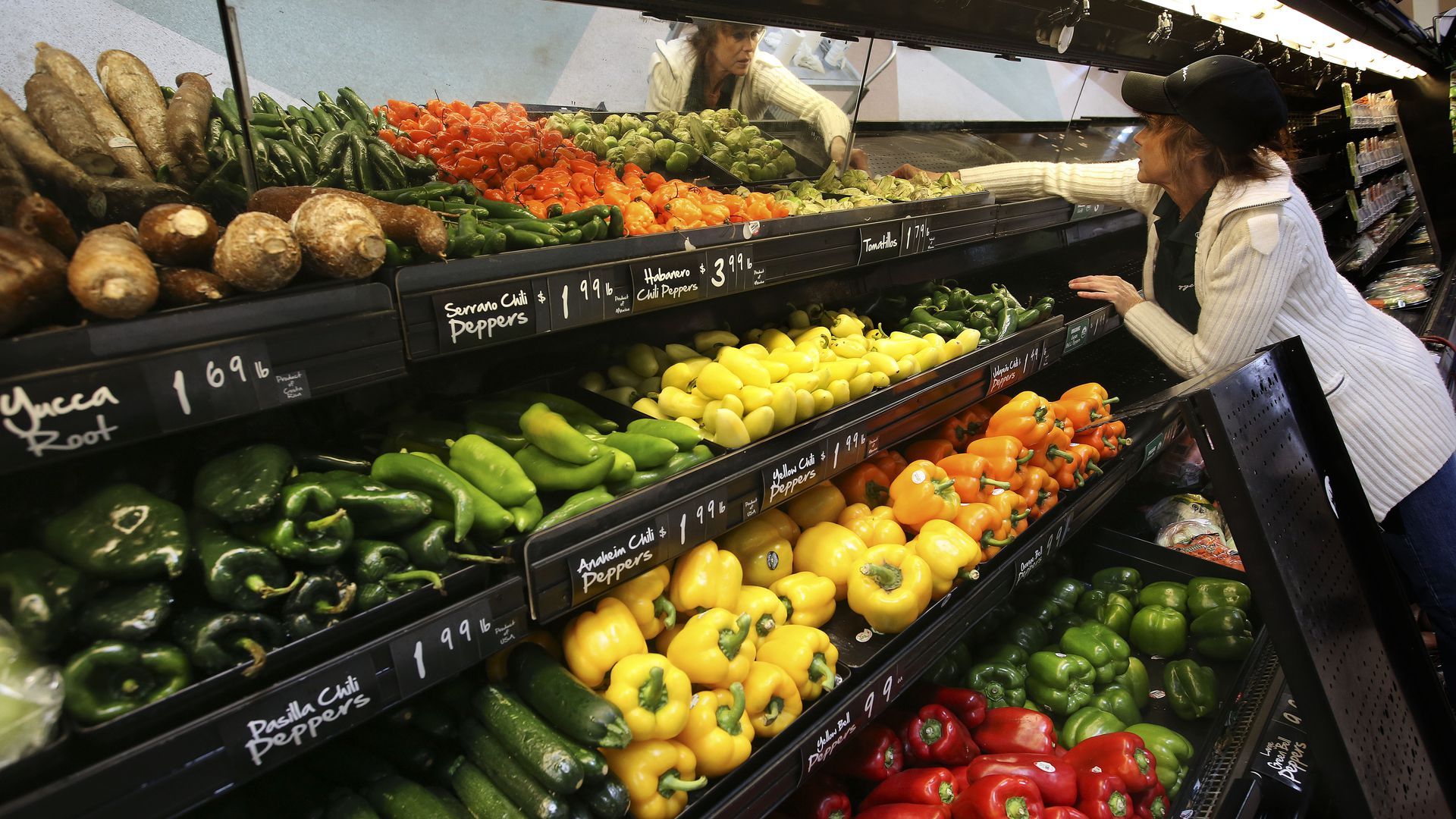 grocer filling up produce stock