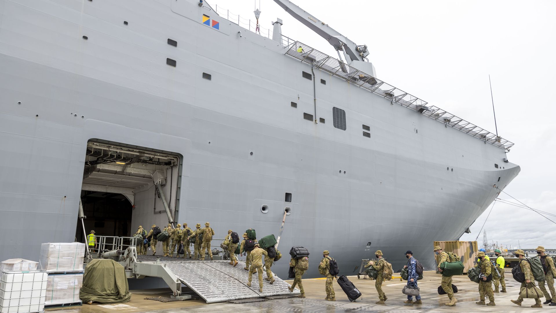 Members of the Australian Defense Force board the HMAS Adelaide as they prepare to depart for an aid mission at the Port of Brisbane on January 20, 2022. 
