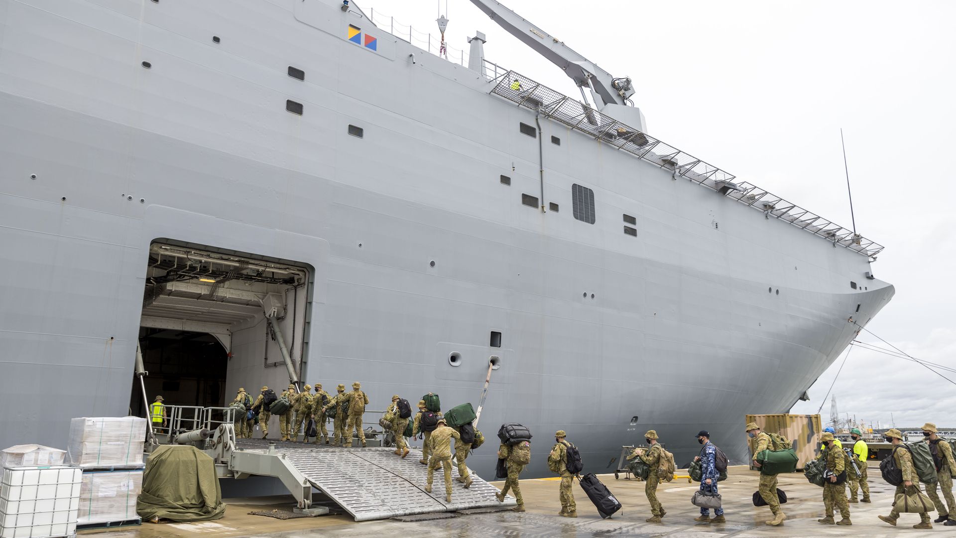 Members of the Australian Defense Force board the HMAS Adelaide as they prepare to depart for an aid mission at the Port of Brisbane on January 20, 2022.